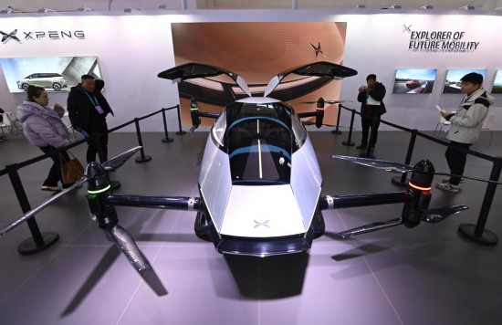 2023年12月1日，在鏈博會智能汽車鏈展區(qū)小鵬汽車展臺，參觀者觀看一臺智能飛行器。新華社記者蔡湘鑫攝