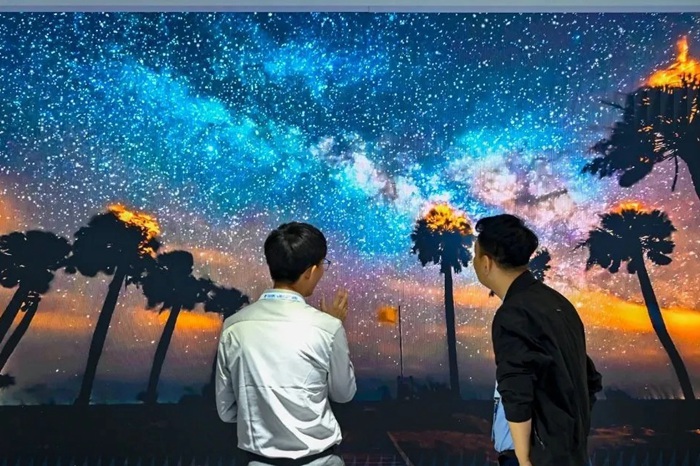 長春光博會(huì)希達(dá)電子展區(qū)，一位工作人員正在給一位觀眾講解。（長春新區(qū)供圖）