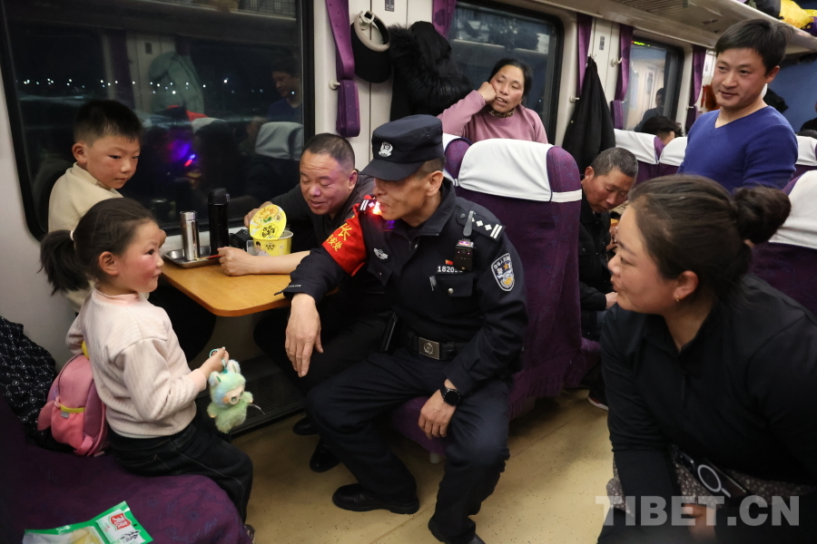 乘警長左紅彬在巡視車廂間隙，向攜帶兒童的旅客專門叮囑安全注意事項。.JPG
