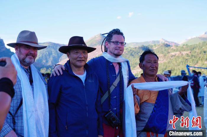 圖為當(dāng)?shù)孛癖娕c外籍?dāng)z影師合影留念。　馬銘言 攝