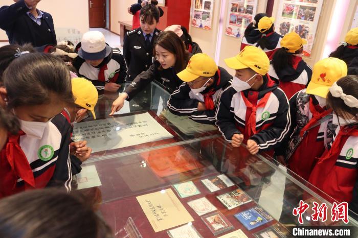 圖為亞東邊檢站民警為駐地小學生講解該站榮譽發(fā)展史。　胡利媛 攝