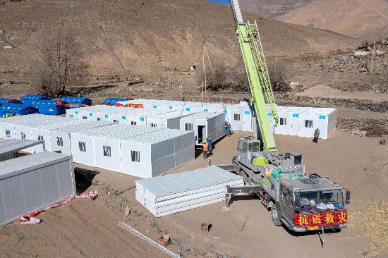 2025年1月9日，在定日縣長(zhǎng)所鄉(xiāng)古榮村安置點(diǎn)，救援人員和施工人員合力抓緊搭建移動(dòng)板房，確保受災(zāi)群眾溫暖過冬。人民網(wǎng)記者 翁奇羽攝